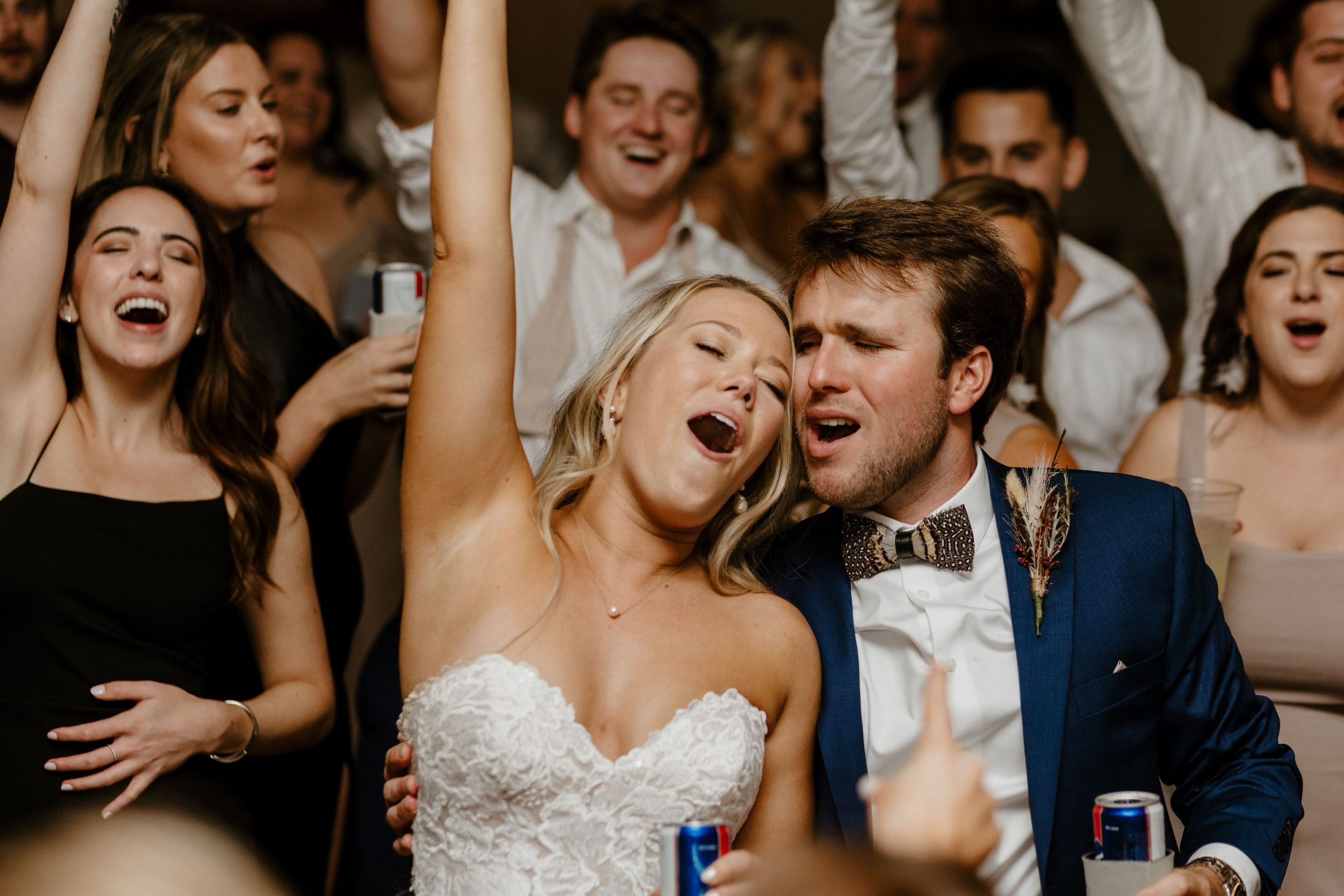 A bride and groom singing along with their guests on the dance floor at a north Georgia wedding