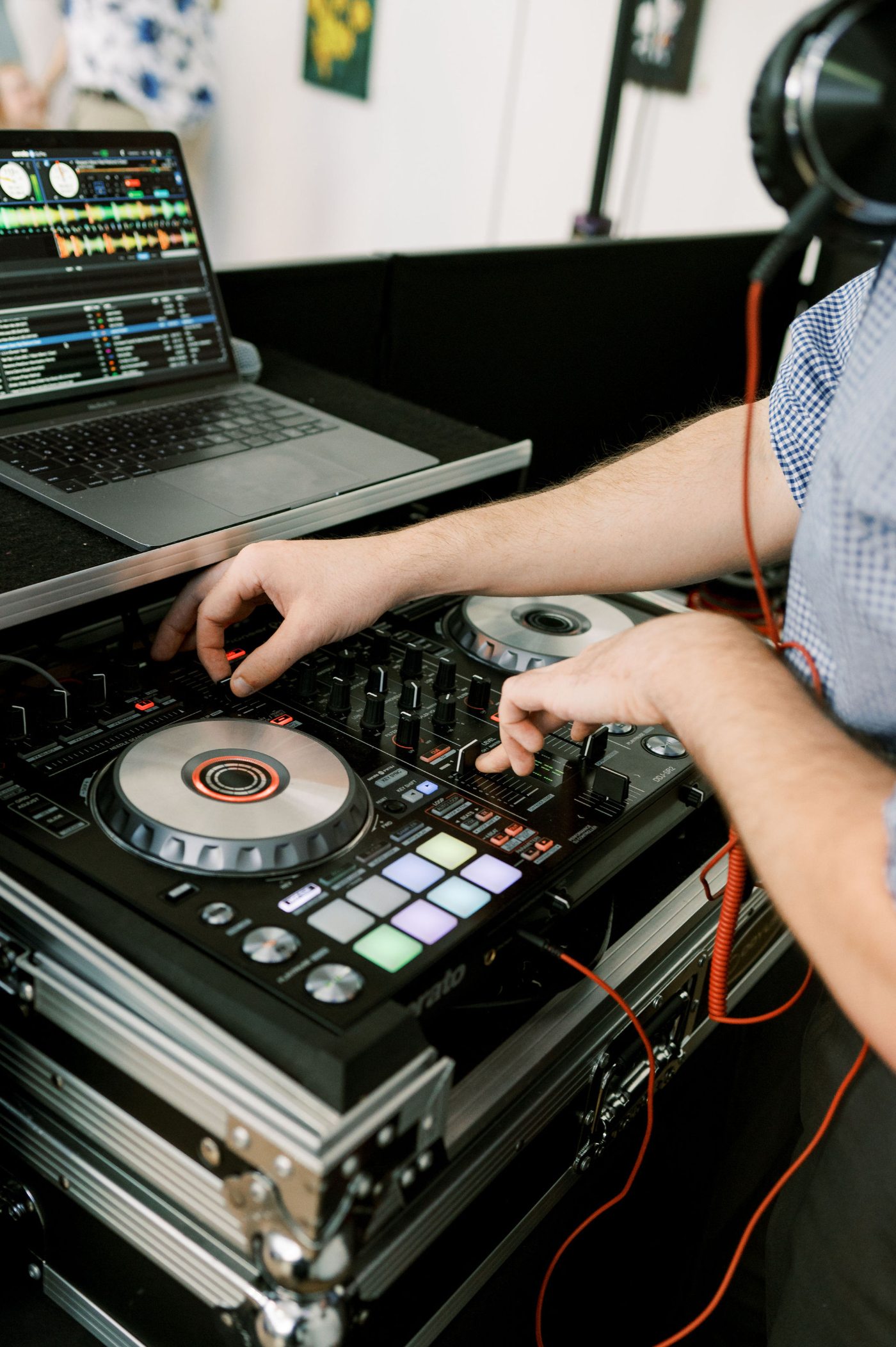 A Nightbird DJ working a controller and laptop from behind the booth at a north Georgia wedding